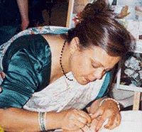 the henna  artist drawing more henna