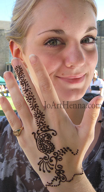 girl showing off here beautiful henna design at craft fair 